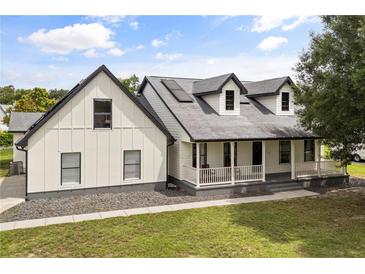 Charming two-story modern farmhouse with a covered porch and manicured lawn at 2050 Jan Lan Blvd, St Cloud, FL 34772