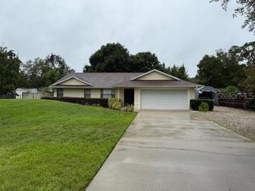 Charming single-story home featuring a well-maintained lawn and a two-car garage, nestled in a serene neighborhood at 2342 Audley St, Oviedo, FL 32765