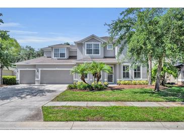 Charming two-story home featuring a well-manicured lawn, a three-car garage, and welcoming curb appeal at 384 Old Alemany Pl, Oviedo, FL 32765