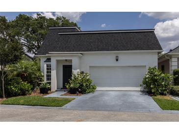 Charming single-story home with a two-car garage and well-maintained landscaping at 907 Sussex Close # 4, Orlando, FL 32804