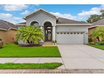 Lovely single-Gathering home boasting a manicured lawn, lush landscaping, and an attached two-car garage at 1035 Stoney Creek Dr, Lakeland, FL 33811