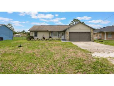 Charming single-Gathering home featuring stone accents, a well-manicured lawn, and an attached two-car garage at 1785 6Th Ave, Deland, FL 32724