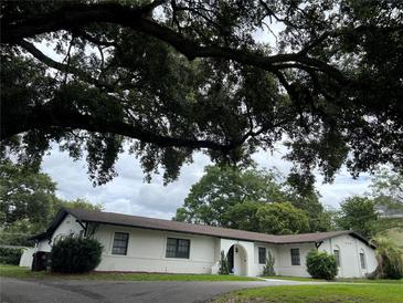 Charming one-story home with a beautiful oak tree in the front yard providing shade at 1809 Pepperidge Dr, Orlando, FL 32806