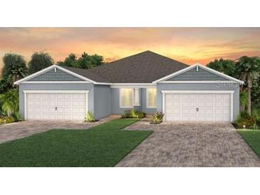 Charming single-Gathering home with lush green lawn, brick paved driveway, and an attached two-car garage at 2334 Daisy Tree Rd, St Cloud, FL 34771