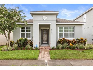 Charming single-story home with a well-manicured lawn, beautiful landscaping, and a welcoming entryway at 2417 Liner Ave, Apopka, FL 32703