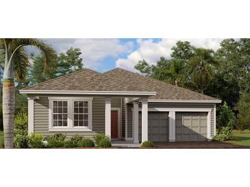 Charming single-story home with a gray exterior, well-manicured landscaping and an attached two car garage at 30166 Rustic Mill Street, Mount Dora, FL 32757