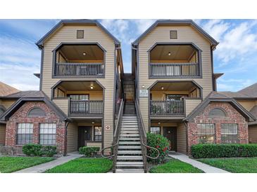 Condo exterior with two-story facade, balconies, and central staircase at 351 Lone Hill Dr # 206, Altamonte Springs, FL 32701