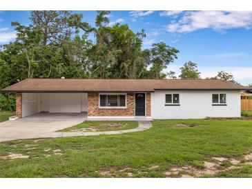 Charming single-story home featuring brick accents, an open carport, and a well-maintained lawn at 4116 Sw 20Th St, Ocala, FL 34474