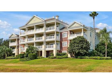 Stunning condo building featuring multiple balconies and lush landscaping, perfect for enjoying the outdoors at 7616 Cabana Ct # 301, Reunion, FL 34747