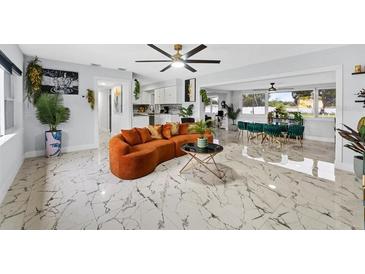 Bright, open living room with modern decor, marble floors, and neutral paint at 8120 Gondola Dr, Orlando, FL 32809