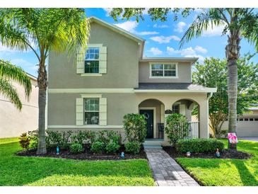 Charming two-story home featuring landscaped front yard and inviting covered porch at 15613 Camp Dubois Cres, Winter Garden, FL 34787