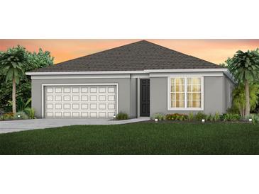 Charming single-story home with a gray exterior, well-manicured lawn, and a two-car garage at 1562 Timber Leaf Rd, St Cloud, FL 34771