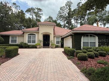 Charming single-story home with a brick driveway and well-manicured landscaping at 3429 Regal Crest Dr, Longwood, FL 32779