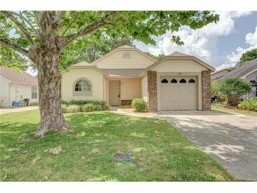 Charming single-story home with a well-manicured lawn and a cozy, welcoming facade at 123 Edgewater Cir, Sanford, FL 32773