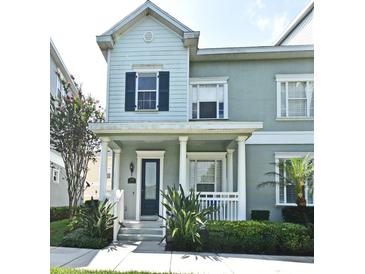 Charming two-story townhouse with a welcoming front porch and well-maintained landscaping at 335 Lansbrook Ln, Winter Springs, FL 32708