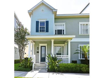 Charming two-story home featuring a covered porch with white columns and beautifully landscaped front yard at 335 Lansbrook Ln, Winter Springs, FL 32708