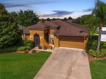 Charming single-story home features a well-manicured lawn, mature landscaping, and a welcoming entrance at 3562 Foxchase Dr, Clermont, FL 34711