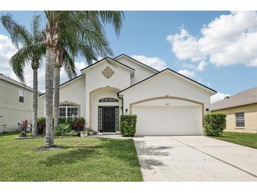 Charming single-Gathering home with mature palm trees and a well-manicured lawn at 504 Key Haven Dr, Sanford, FL 32771