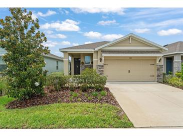 Charming single-story home with well-maintained landscaping, beautiful lawn, and two car garage at 5395 Sunshine Dr, Wildwood, FL 34785
