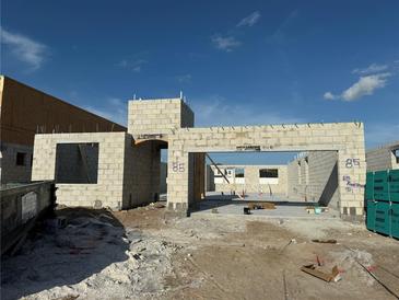 Construction site showing the concrete block walls and foundation of a new residential building under a blue sky at 813 River Stone Trl, Sanford, FL 32771