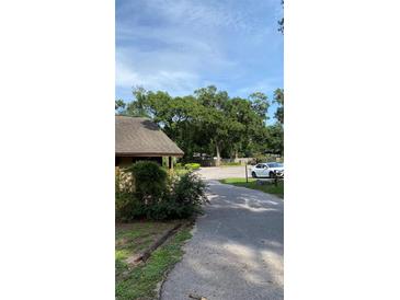 Wide view of a parking area and partial view of a building exterior at 1022 Love Ln # 35, Apopka, FL 32703