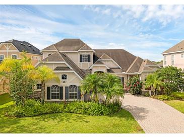 Charming two-story home with lush landscaping and a brick driveway at 16120 Bristol Lake Cir, Orlando, FL 32828