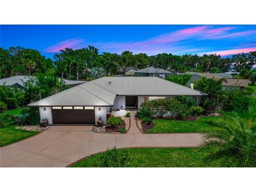 Stunning single-story home boasting a well-manicured lawn and a modern metal roof for lasting curb appeal at 225 Temple Cir, Eustis, FL 32726