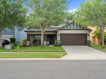 Charming single-story home with a well-manicured lawn and a two-car attached garage at 2604 Bullion Loop, Sanford, FL 32771