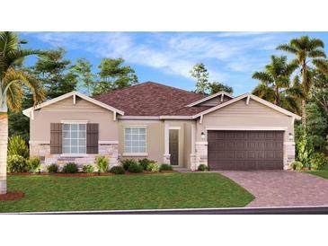 Charming single-story home with a manicured lawn, stone accents, and a two-car garage at 2927 Believe In Yourself Ct, Clermont, FL 34714