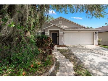 Charming single-story home featuring a two-car garage, landscaped yard, and inviting front entrance at 3121 Natoma Way, Orlando, FL 32825