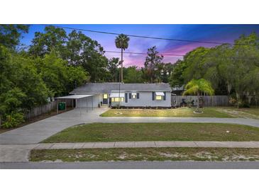 Charming single-story home with well-maintained lawn, carport, and inviting curb appeal, perfect for a cozy Gathering residence at 330 N Stone St, Deland, FL 32720
