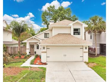 Charming two-story home featuring a two-car garage, lush landscaping, and inviting front entrance at 345 Goldstone Pl, Lake Mary, FL 32746