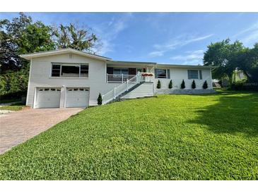Charming two-story home with white siding, well-manicured lawn, and attached two-car garage at 3702 Mirror Lake Dr, Apopka, FL 32703