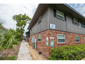 Exterior view of building with brick facade, landscaping, and address sign at 851 Miles Ave # 8, Winter Park, FL 32789