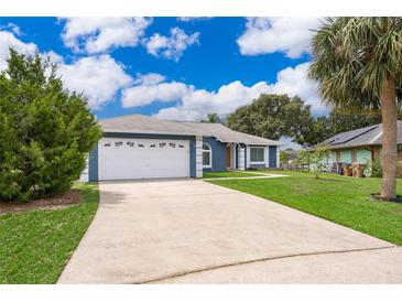 Charming single-story home featuring a well-manicured lawn and a two-car garage at 1115 Marni Ridge Ct, Kissimmee, FL 34747