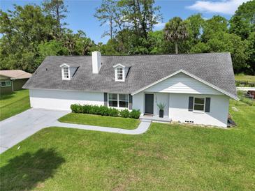 Charming home with dormer windows, gray roof, manicured lawn, and a welcoming walkway at 1836 Se 6Th Ave, Ocala, FL 34471