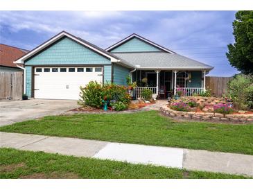 Charming single-story home with lush landscaping and a welcoming front porch at 8718 Fort Shea Ave, Orlando, FL 32822