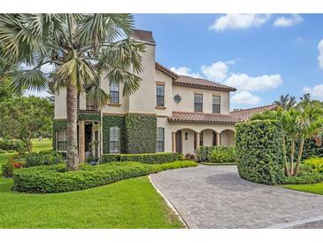 An elegant two-story home featuring lush landscaping, a circular driveway and tasteful architectural details at 922 N Pennsylvania Ave, Winter Park, FL 32789