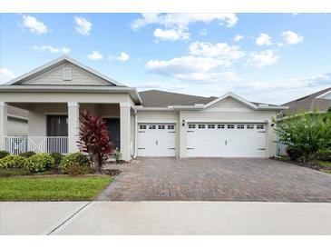 Charming single-Gathering home showcasing a three-car garage and neatly landscaped front yard at 1091 Wood Dale Cir, Oviedo, FL 32765