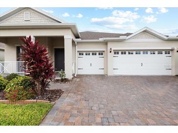 Charming home exterior featuring a two-car garage and meticulously manicured landscaping at 1091 Wood Dale Cir, Oviedo, FL 32765