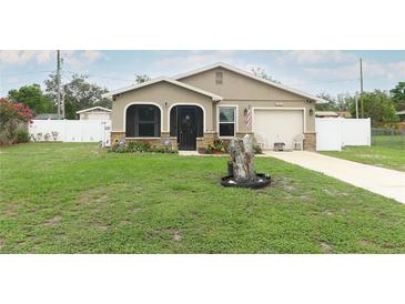Charming home with well-manicured lawn, stone accents, and an attached one-car garage at 1078 Aaron Dr, Deltona, FL 32725