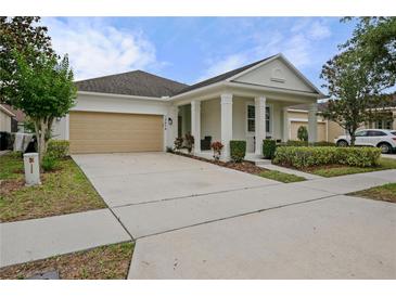 Charming single Gathering home showcasing a well-manicured lawn and a beige two-car garage at 12679 Calderdale Ave, Windermere, FL 34786