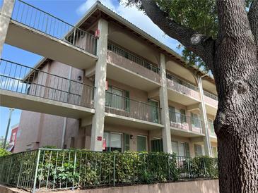 Multi-level condo building with balconies, green shutters, and gated entries at 145 Oyster Bay Cir # 200, Altamonte Springs, FL 32701