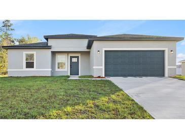 Charming single-story home with modern design, manicured lawn, and attached two-car garage at 178 Marion Oaks Ln, Ocala, FL 34473