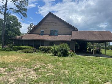Charming two-story home with a carport and front yard showcasing potential at 17952 Lookout Hill Rd, Winter Garden, FL 34787