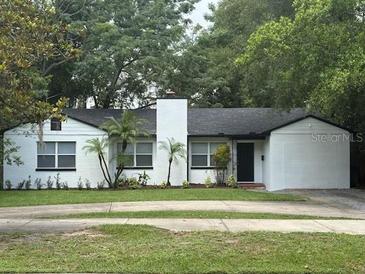 Charming single-story home features a well-maintained lawn and classic white-painted brick facade at 1961 Winter Park Rd, Winter Park, FL 32789
