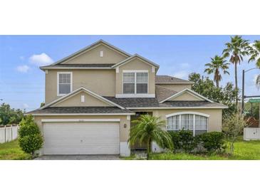Charming two-story home with a two-car garage and well-maintained landscaping at 3222 Eagle Creek Ln, Kissimmee, FL 34746