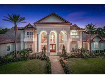 Elegant exterior showcasing grand architecture, lush landscaping, and a pathway leading to the entrance at 3461 Michigan St, Lake Mary, FL 32746