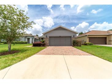Charming single-story home with a two-car garage, stone accents, and landscaped front yard at 3651 Nw 56Th Ave, Ocala, FL 34482