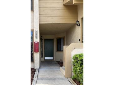 Inviting front entryway showcasing the home's address, a secure door, and exterior lighting for added curb appeal at 4372 Middlebrook Rd # 3, Orlando, FL 32811